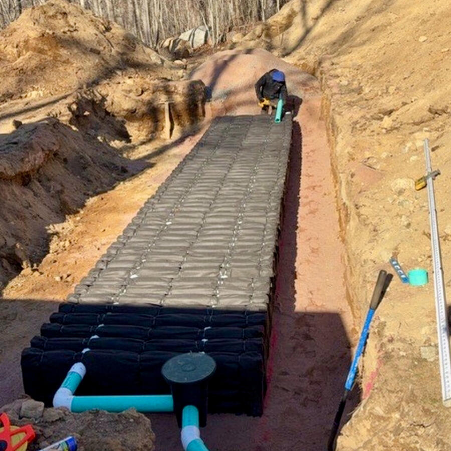 Professional septic tank installation with excavator in Connecticut
