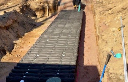 Professional septic tank installation with excavator in Connecticut