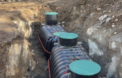 Underground septic tank installation at residential property
